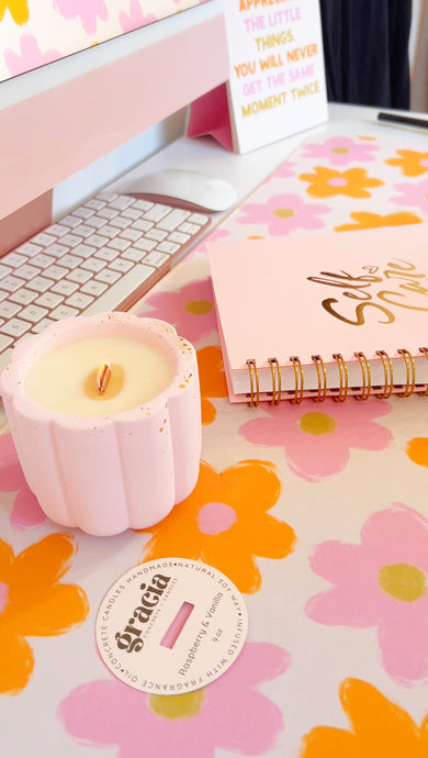 self-care journal and concrete candle